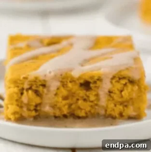Easy 3-ingredient pumpkin cake topped with whipped cream.