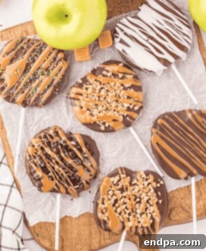 Caramel apple slices decorated with chocolate and sprinkles.