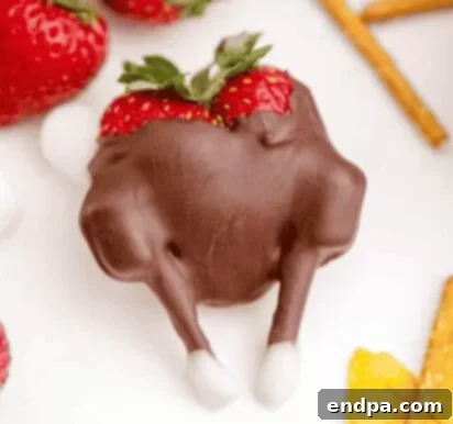 Strawberries dipped in chocolate and decorated like turkeys with colorful candy tails.