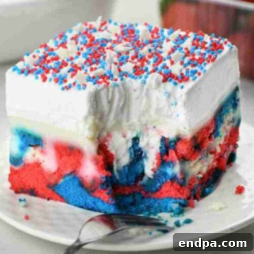 Red White and Blue Cake Masterpieces 8 A slice of Patriotic Poke Cake showcasing vibrant red, white, and blue layers.