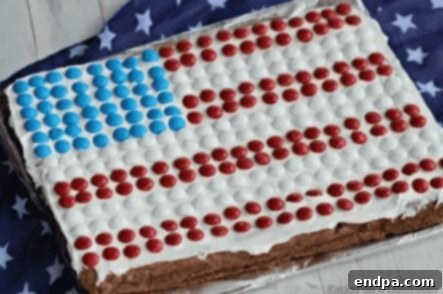 Red White and Blue Cake Masterpieces 6 A festive American Flag Cookie Cake, decorated with red, white, and blue frosting and berries.
