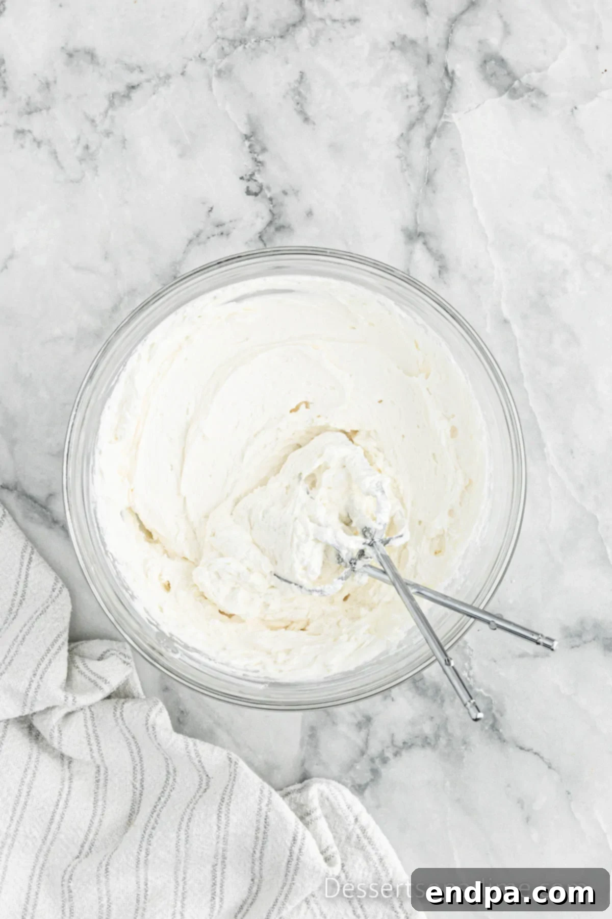 Portable Cupcake Perfection 5 Large mixing bowl with freshly prepared, fluffy buttercream frosting.