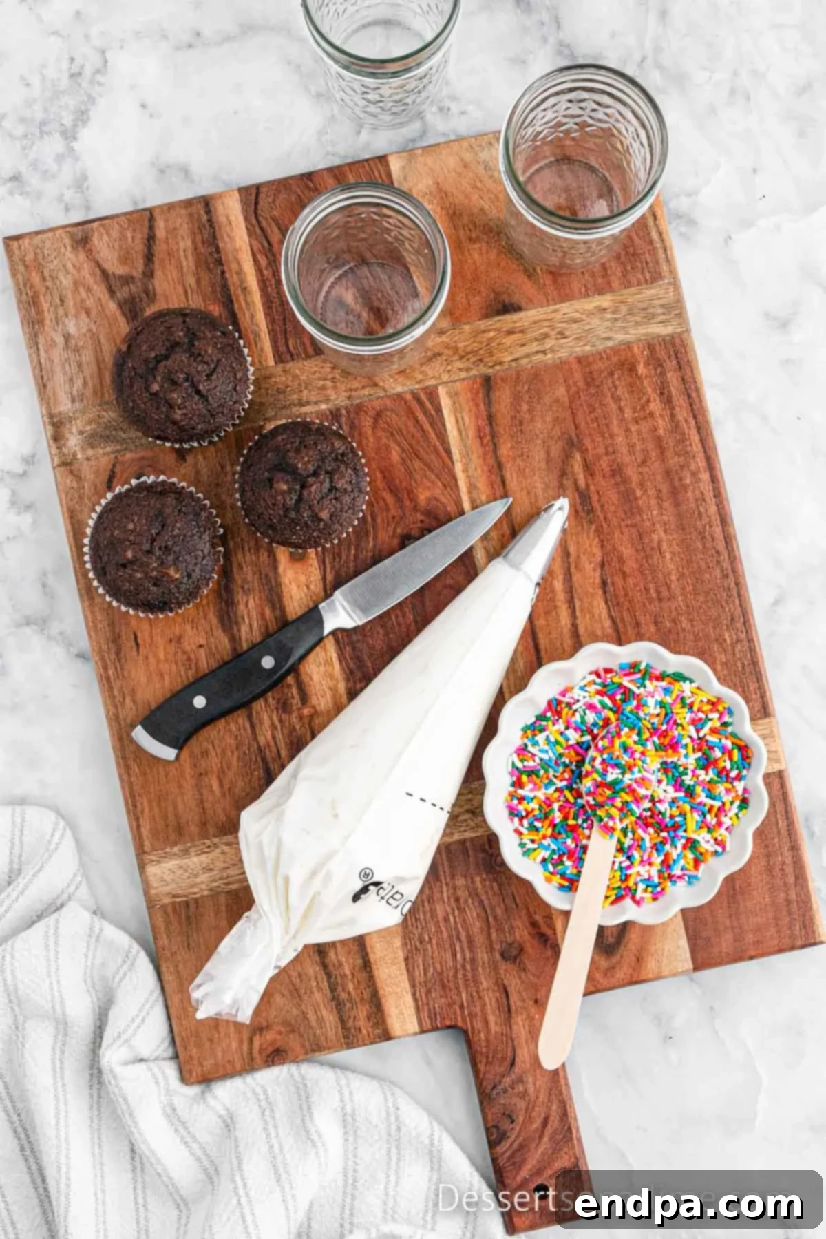 Portable Cupcake Perfection 6 Piping bag filled with frosting, fitted with a decorative star tip.