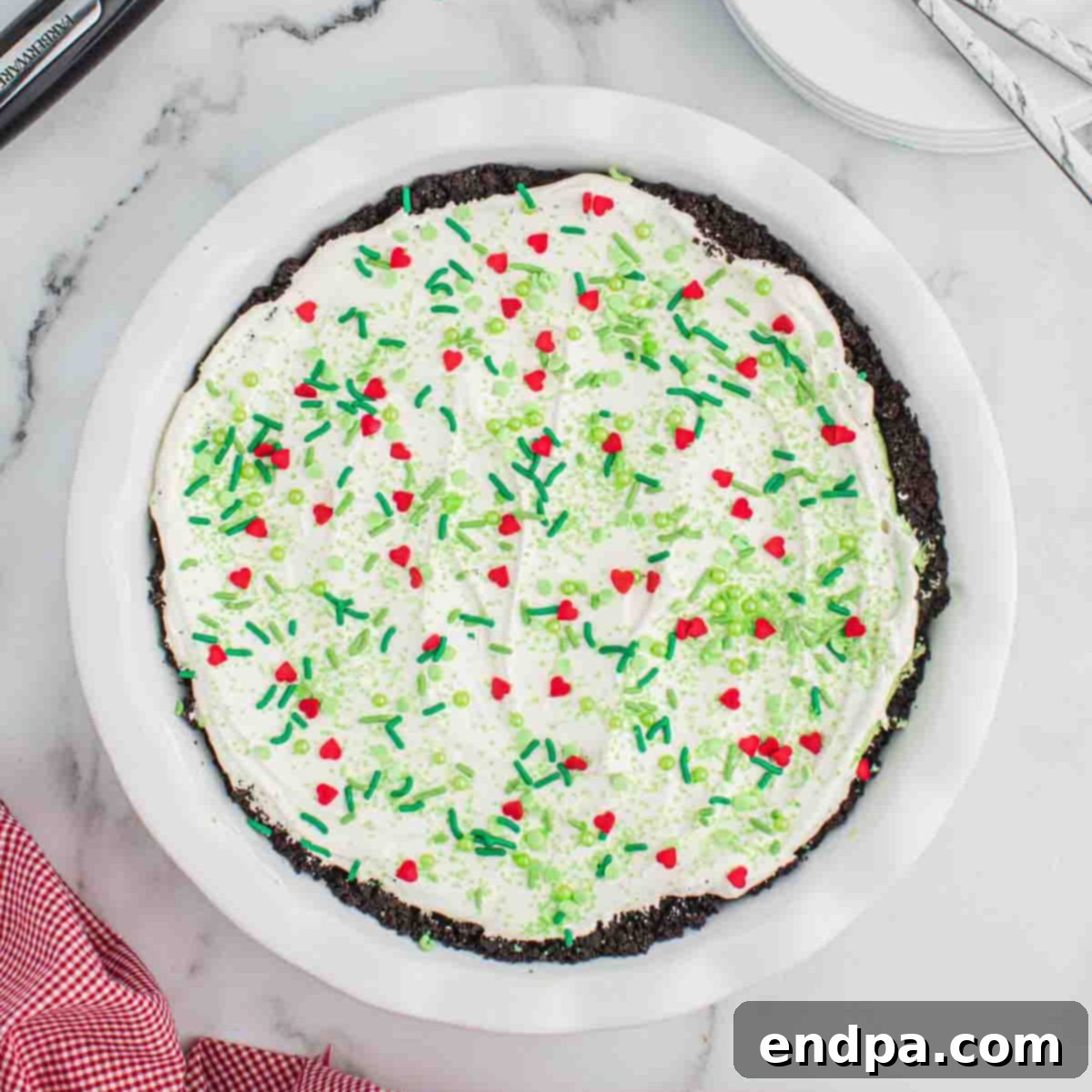 Grinch Pie with sprinkles ready to serve.