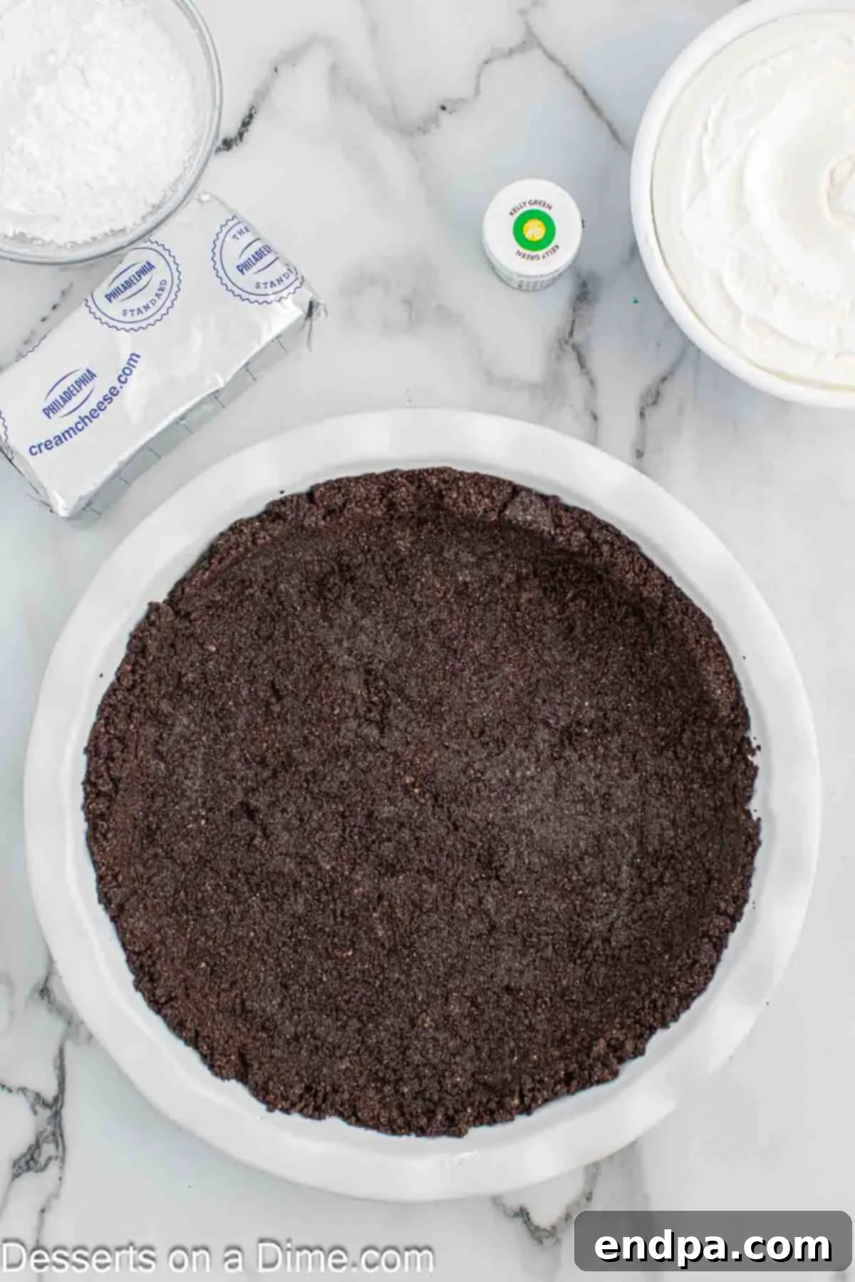 Pressing the Oreo crust into the pie plate.