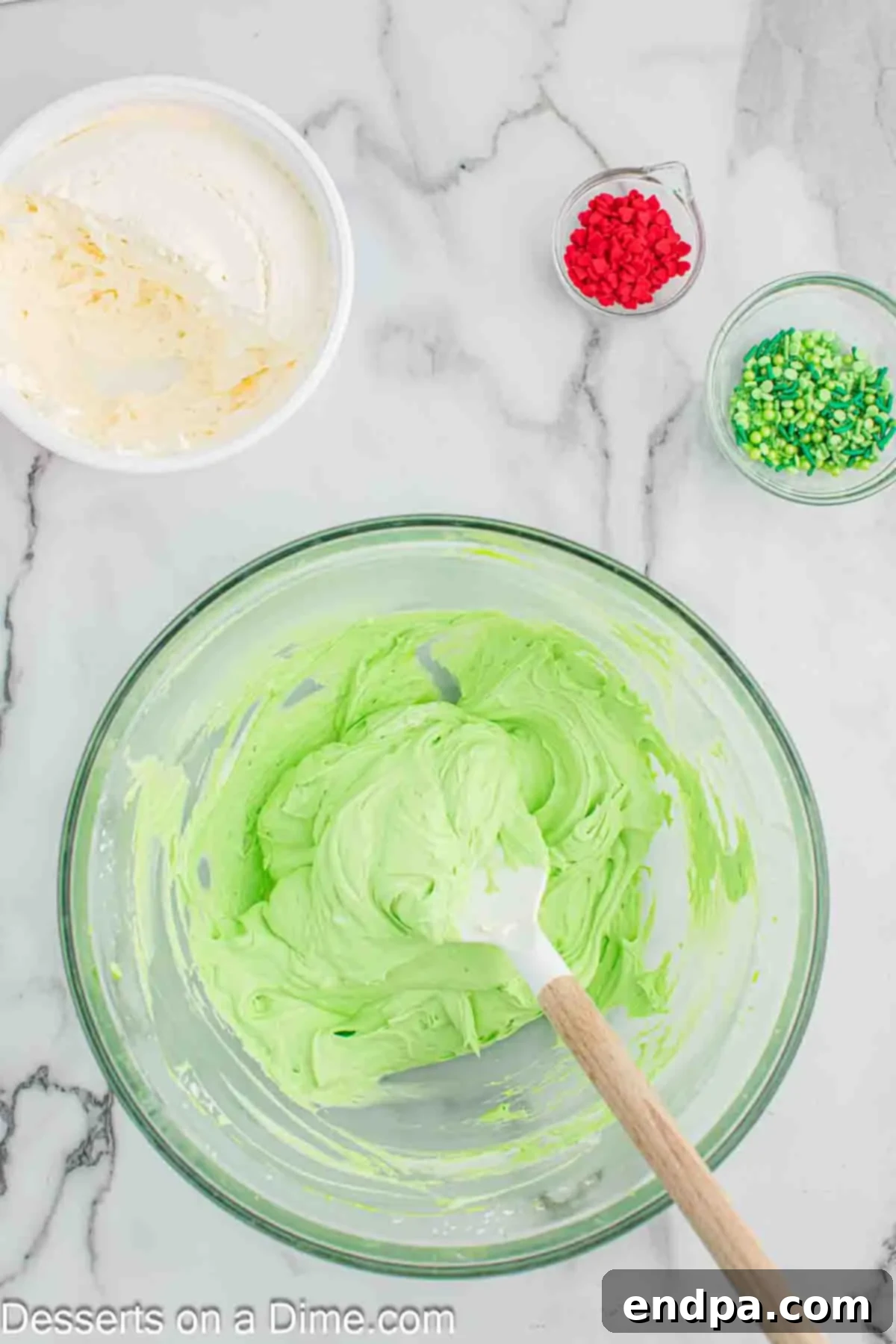 Mixing in the Cool Whip into the green pie filling.