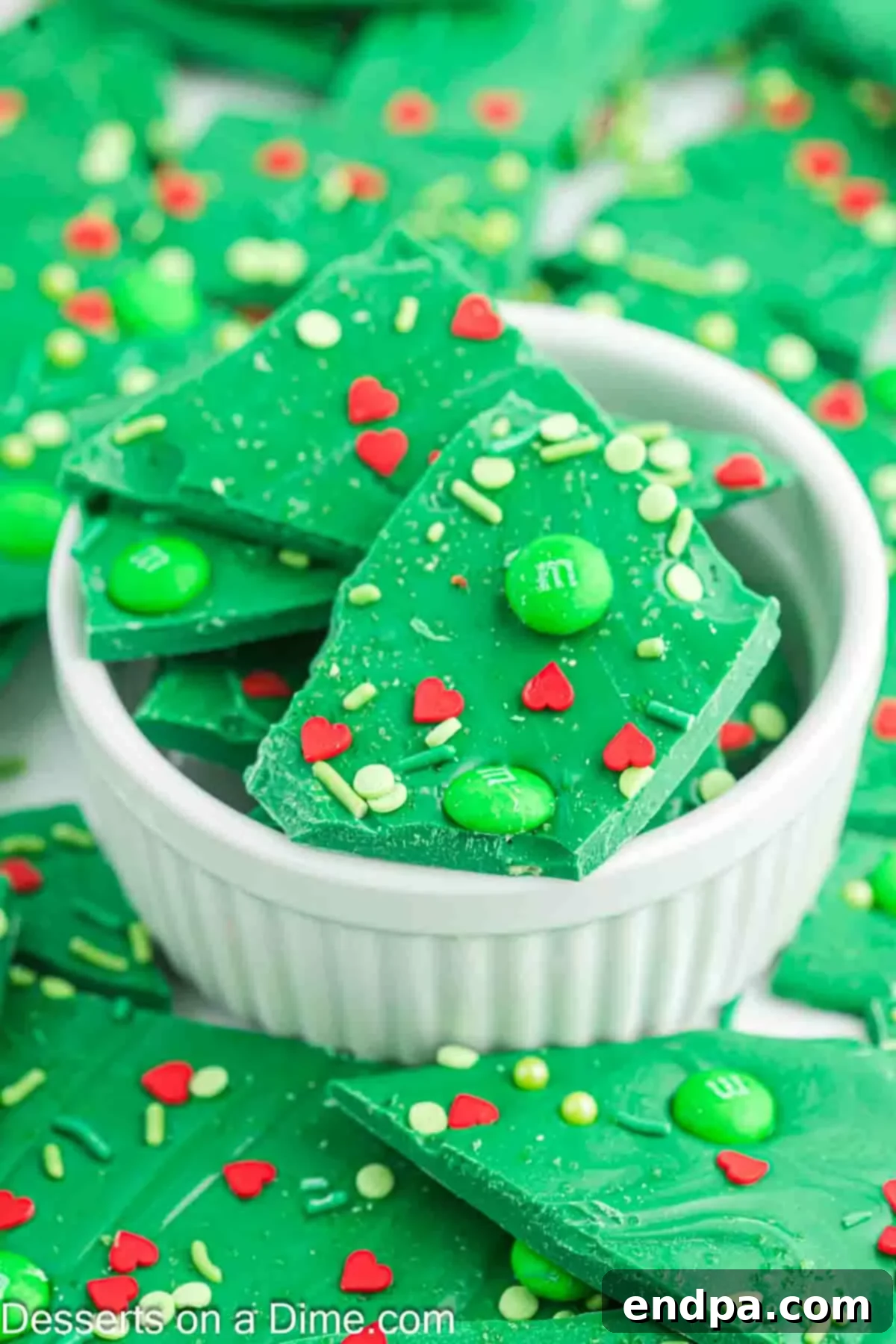 Grinch Bark broken into irregular pieces, served in a white ceramic bowl.