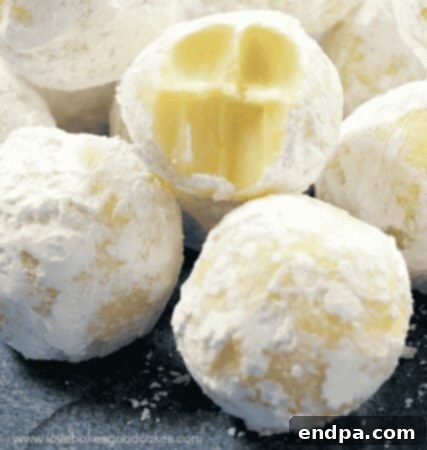 Creamy White Chocolate Lemon Truffles dusted with powdered sugar, perfect for holidays.