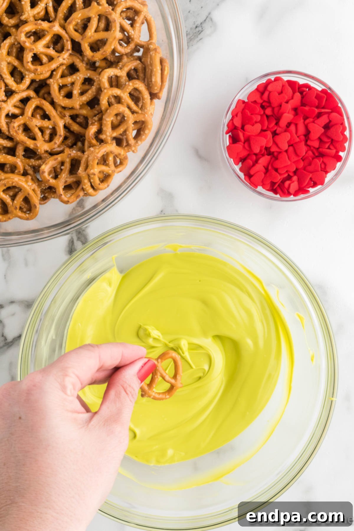 Dipping pretzels into the melted candy melts