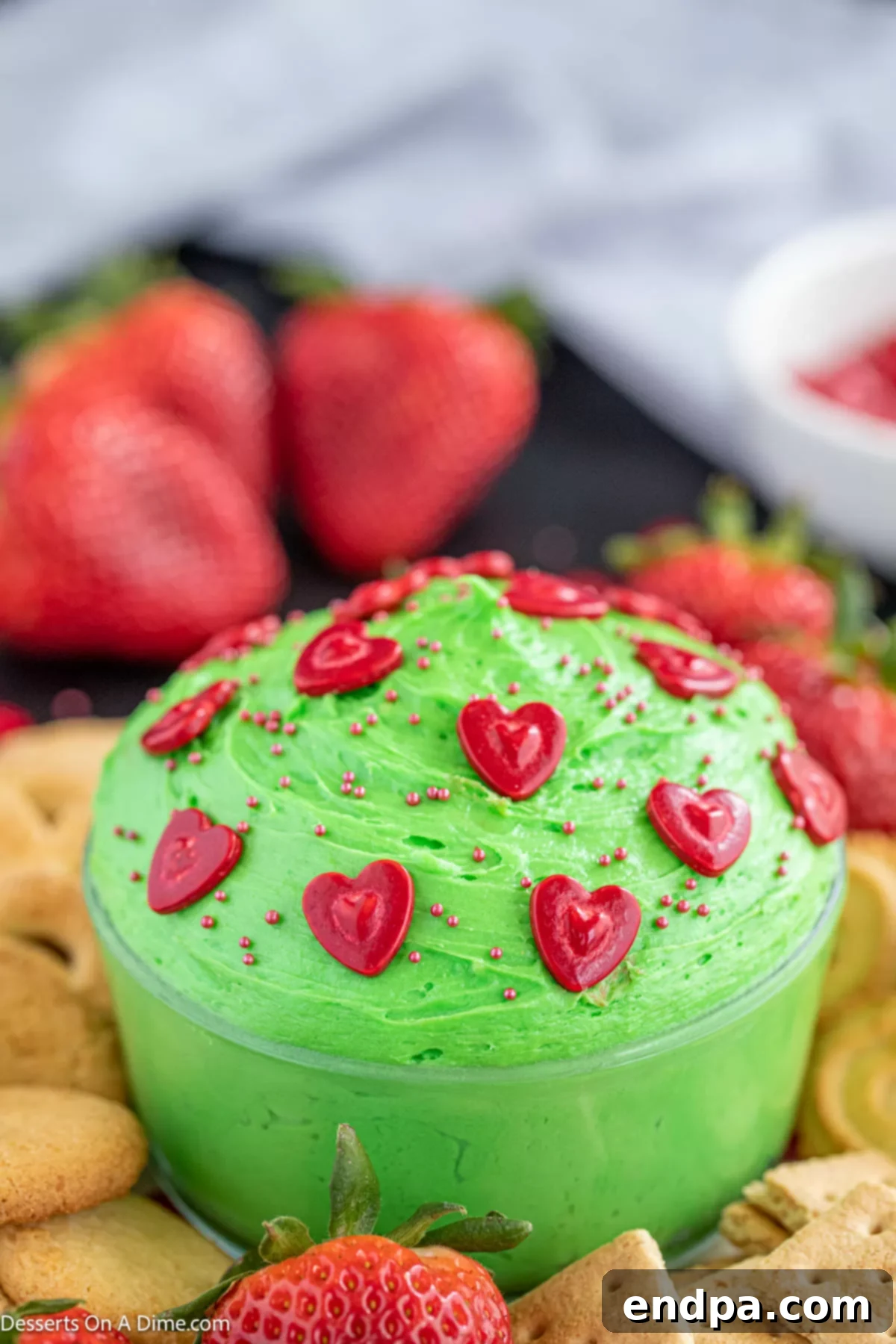 Heart-Growing Grinch Dip 7 A bowl of finished green Grinch dip, ready for serving with dippers.