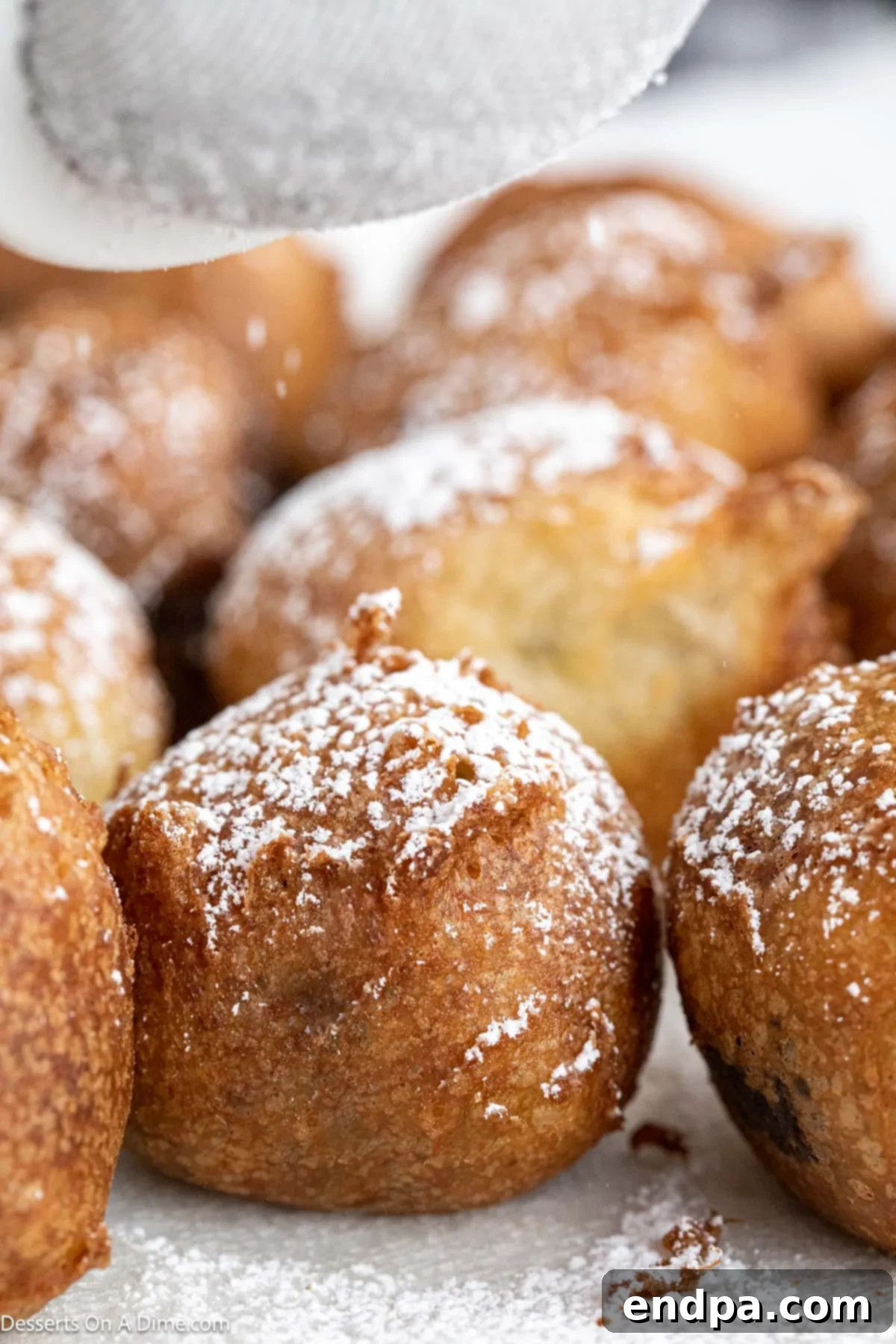 Brownie Bites fried and topped with powdered sugar. 