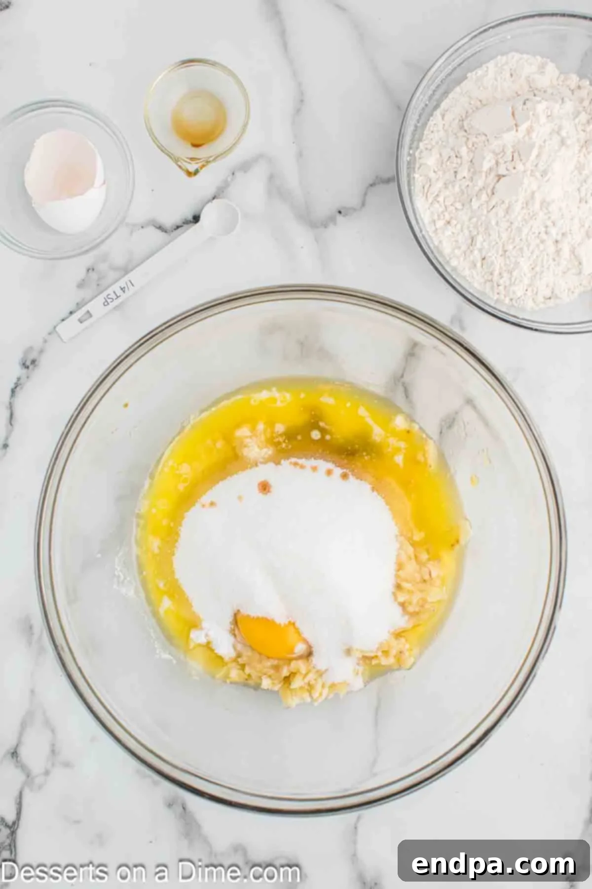 Golden Air Fryer Banana Loaf 4 Mixing bowl with mashed bananas, eggs, and melted butter, ready for combining.