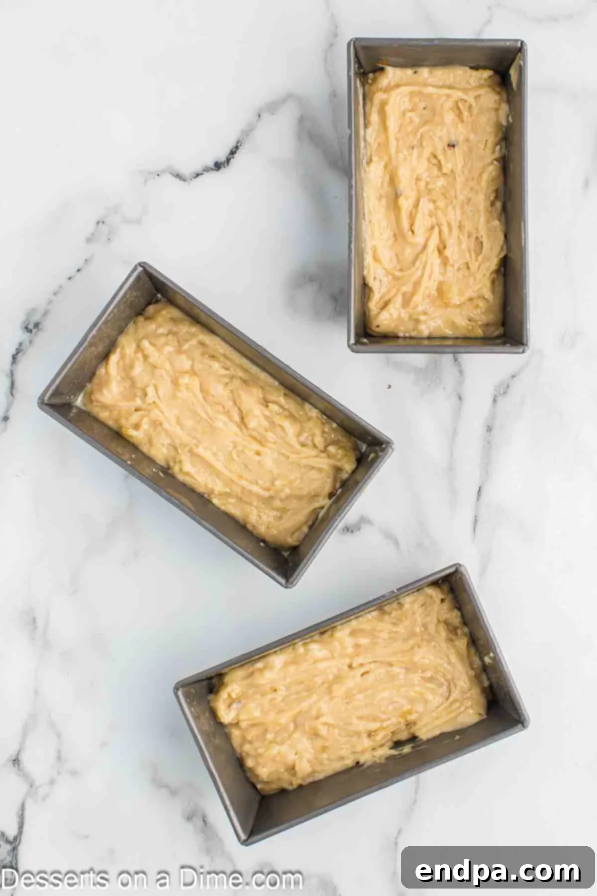 Golden Air Fryer Banana Loaf 6 Banana bread batter poured into mini loaf pans, ready for the air fryer.
