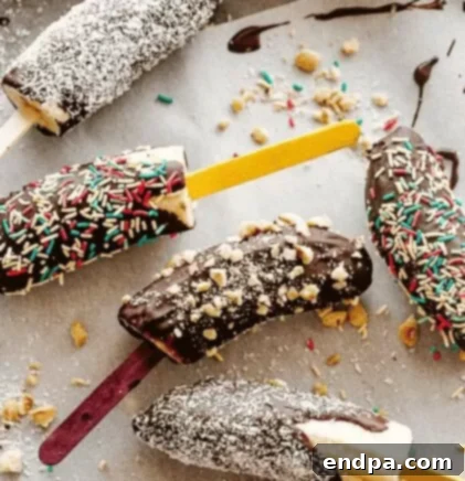 Chocolate covered frozen bananas with various toppings.