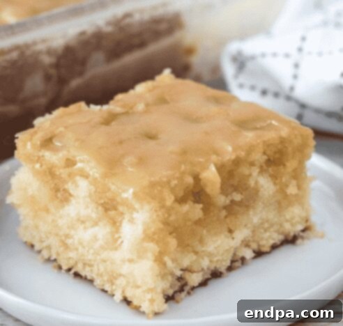 A slice of moist vanilla buttermilk cake with a glaze.