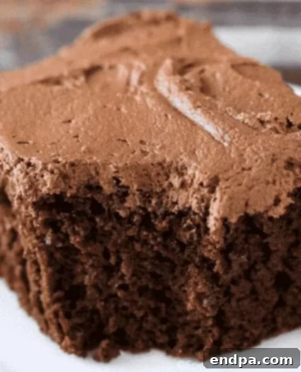 A slice of Chocolate Mayonnaise Cake with chocolate frosting.