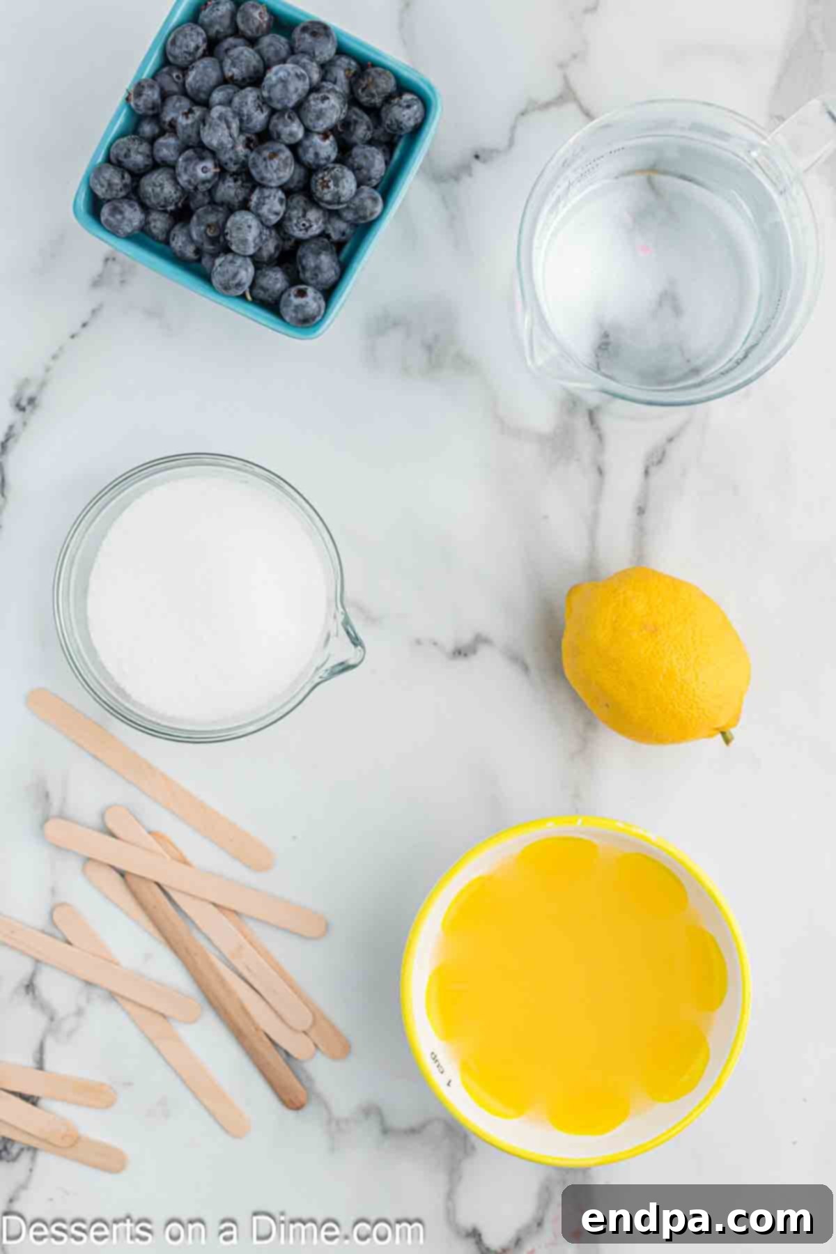 Ingredients for Blueberry lemonade popsicles- lemons, sugar, water, blueberries. 
