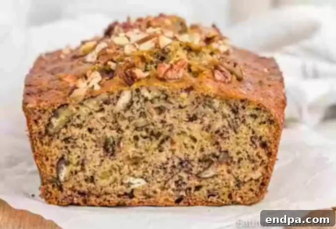 Banana Pecan Bread loaf on a cutting board.