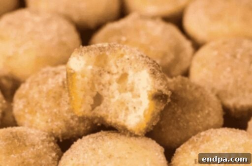 Mini Donut Muffins coated in cinnamon sugar.