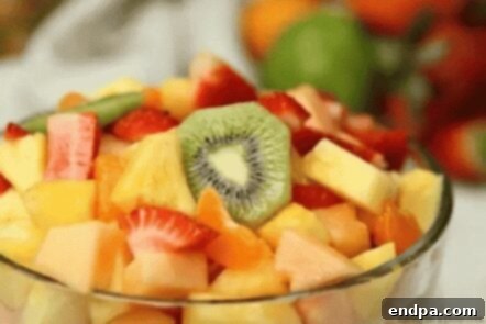 Tropical fruit salad in a glass bowl.