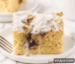 Cinnamon roll cake in a baking dish with a slice cut out.