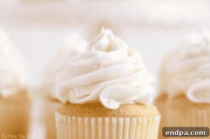 Smooth and creamy vanilla buttercream icing swirled on a dessert.