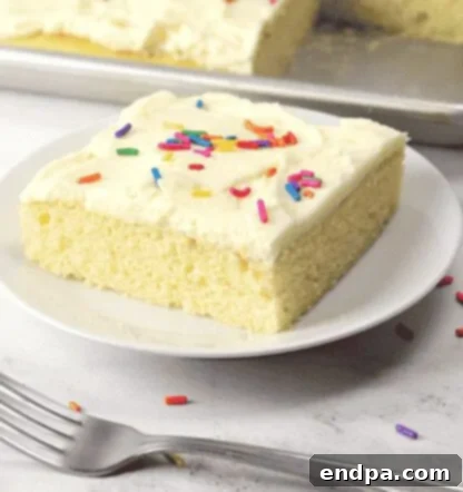 A rectangular vanilla sheet cake with white frosting, ready for serving.