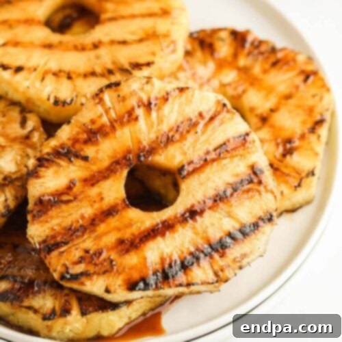 Thick, juicy grilled pineapple slices with visible grill marks.