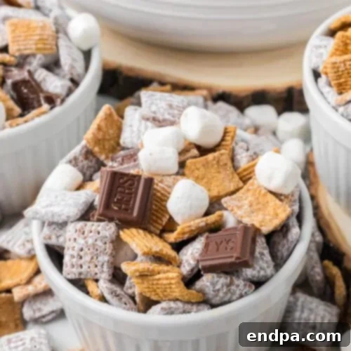 S'mores Puppy Chow in a white bowl, a delicious snack mix with s'mores flavors.