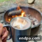 A mug of Campfire Hot Chocolate topped with toasted marshmallows.