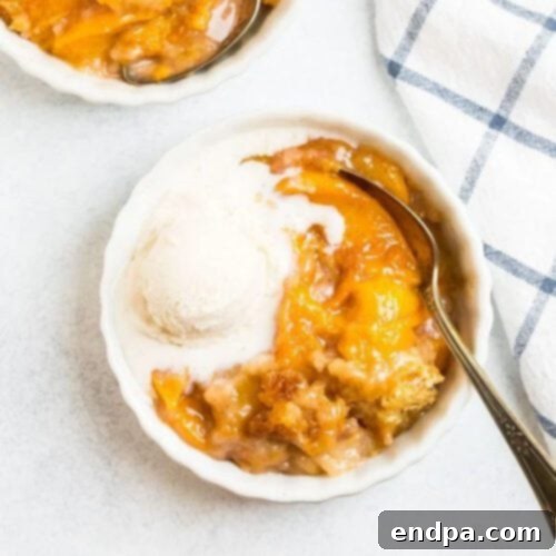 A warm Dutch Oven Peach Cobbler with a golden-brown crust, served directly from the Dutch oven.