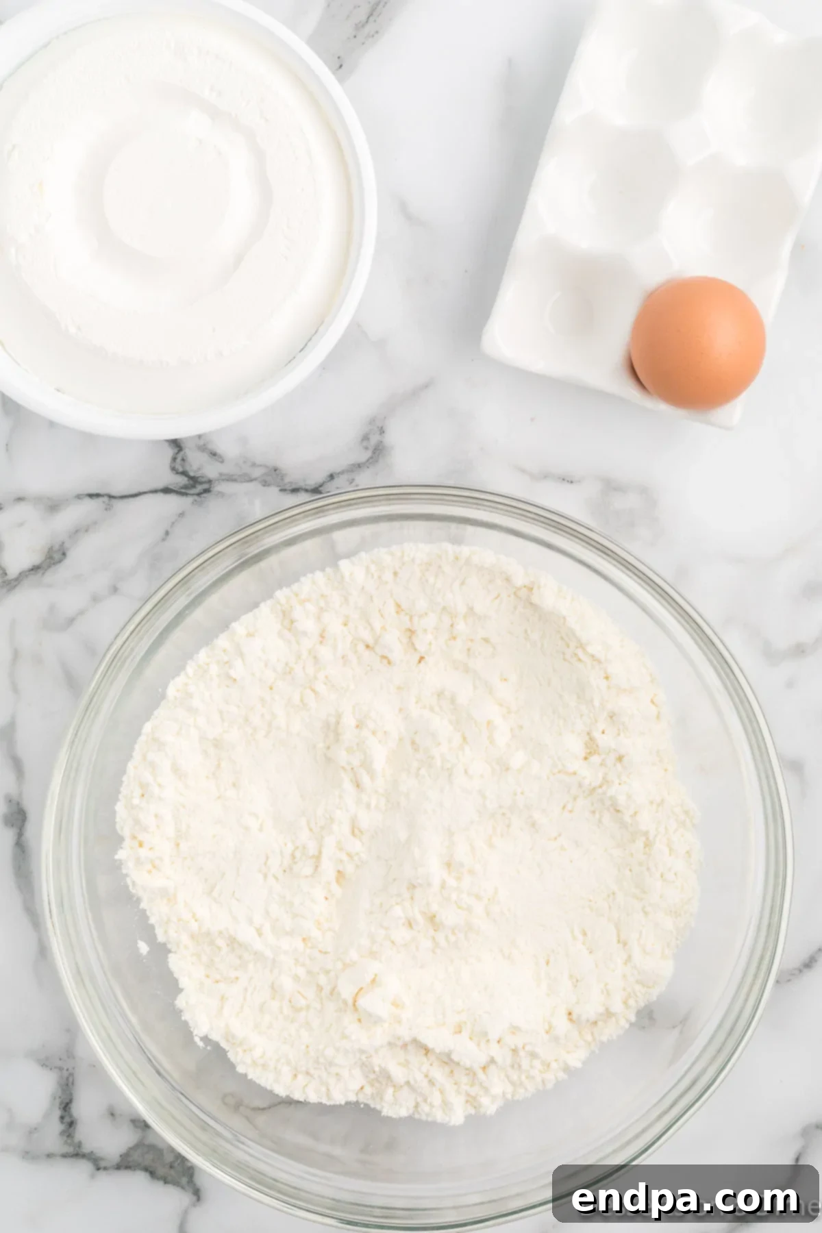 A large mixing bowl containing a bright yellow lemon cake mix.