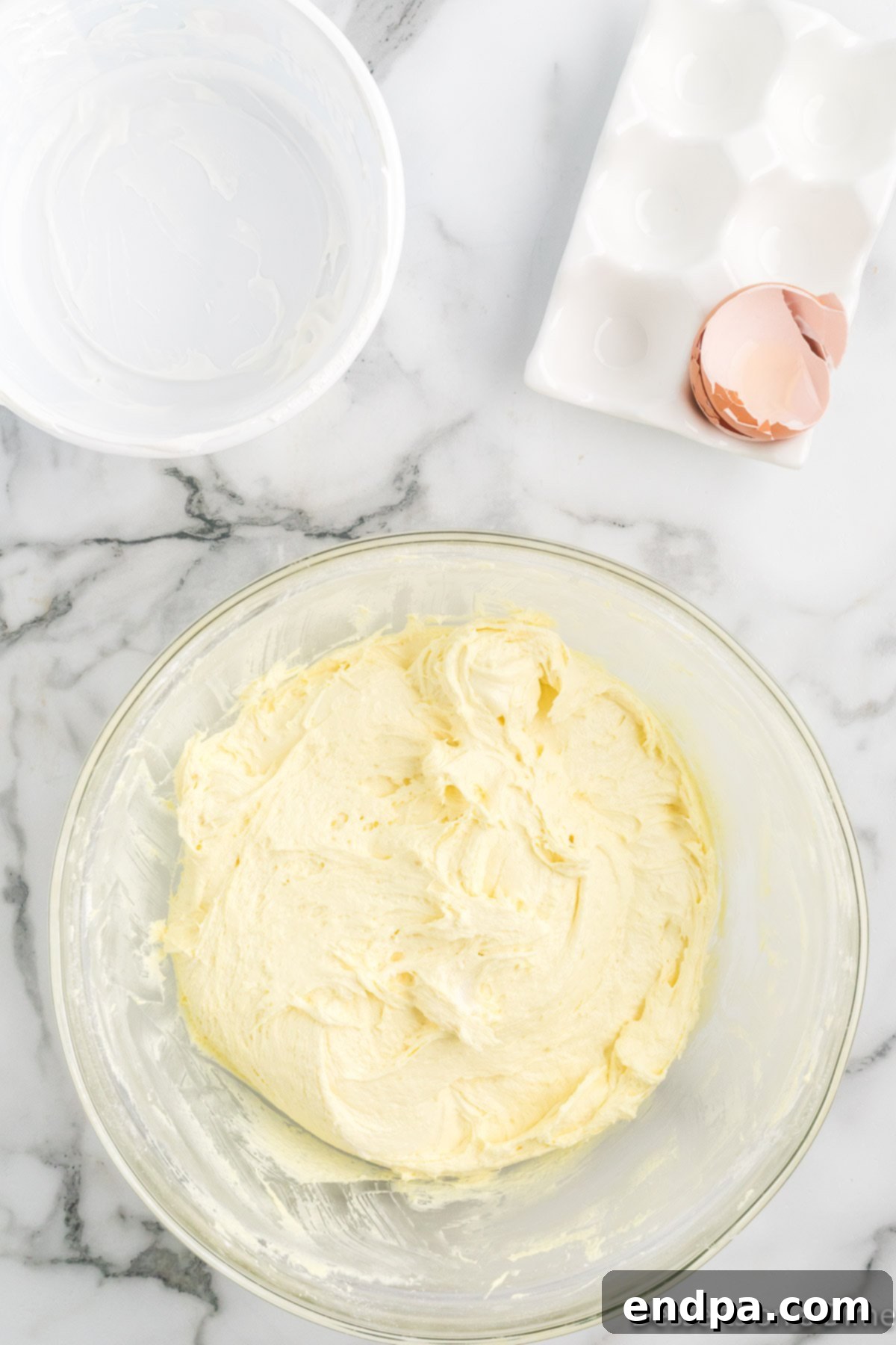The cake mix, cool whip, and egg have been fully combined into a thick, fluffy dough in the bowl.