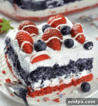 No Bake Summer Berry Lasagna slice with layers of cream, berries, and crust.