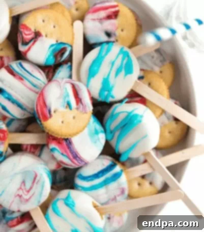 Red, White, and Blue Swirled Chocolate RITZ Cracker Peanut Butter Sandwich Pops.