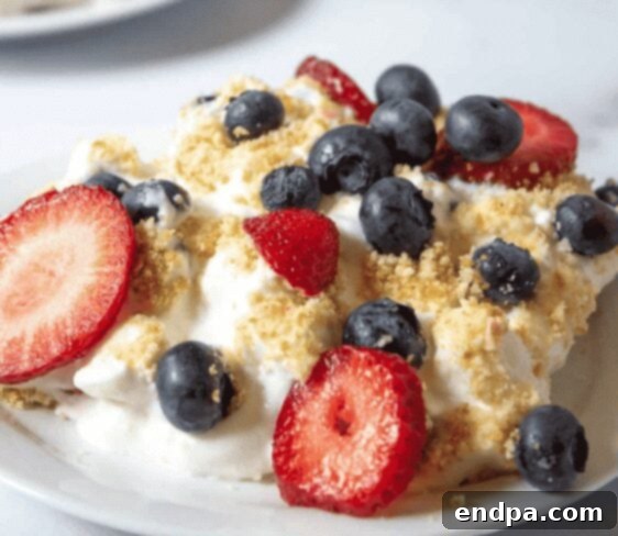 No Bake Berry Delight with layers of whipped cream, berries, and wafers.