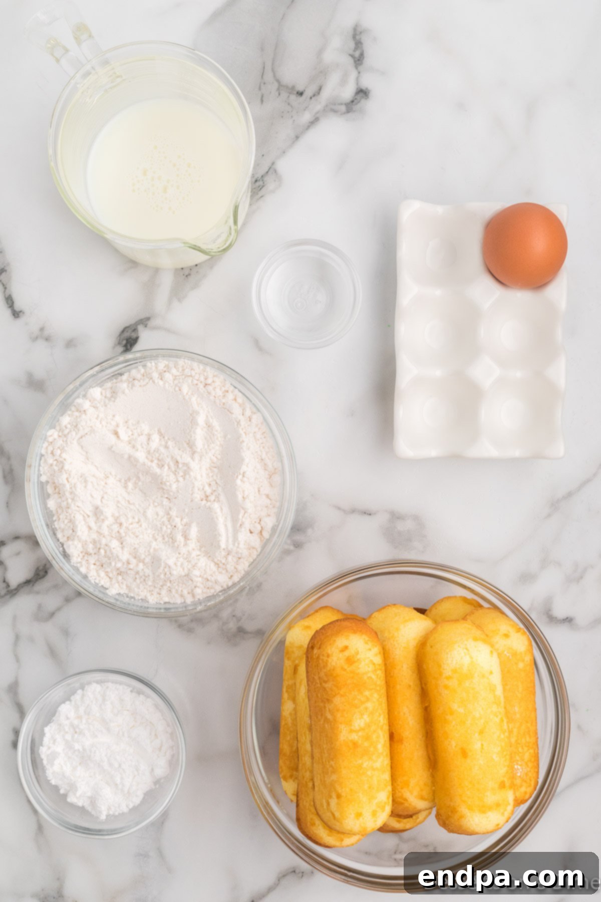 Golden Gooey Goodness 3 Ingredients for Deep fried twinkies - twinkies, powdered sugar, pancake mix, egg, milk, oil.