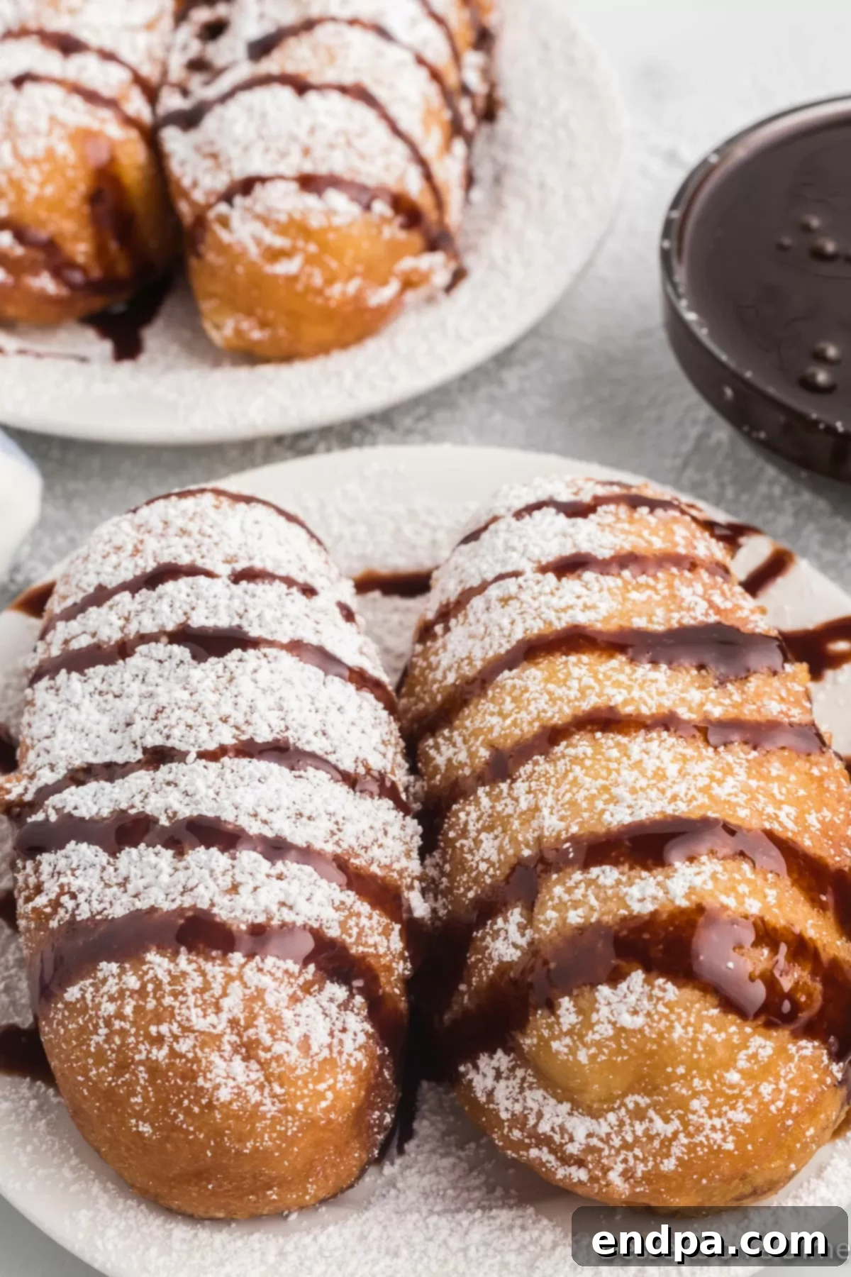 Golden Gooey Goodness 8 Deep fried twinkies with chocolate drizzle on top.