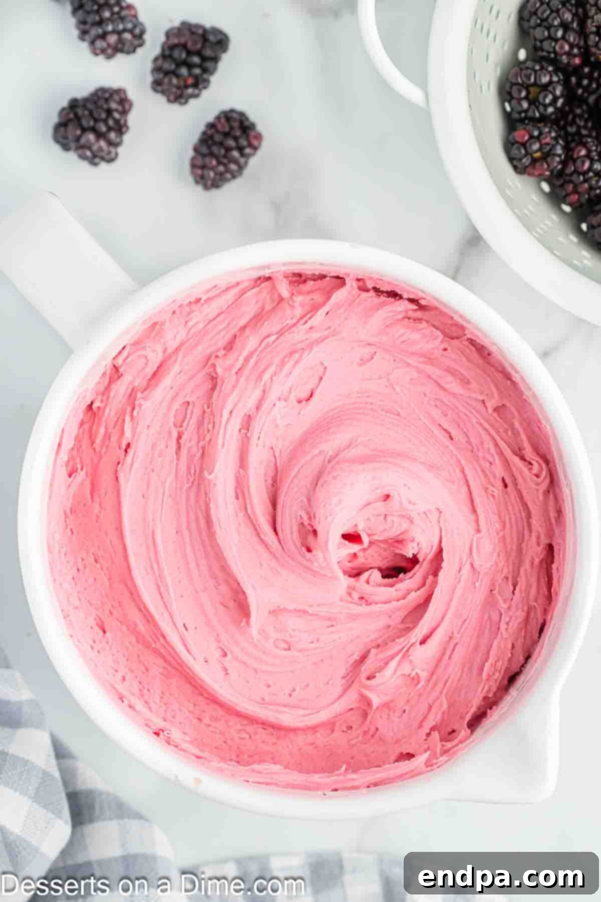 The finished Blackberry Buttercream Frosting neatly placed into a clear container, ready for chilling or use.