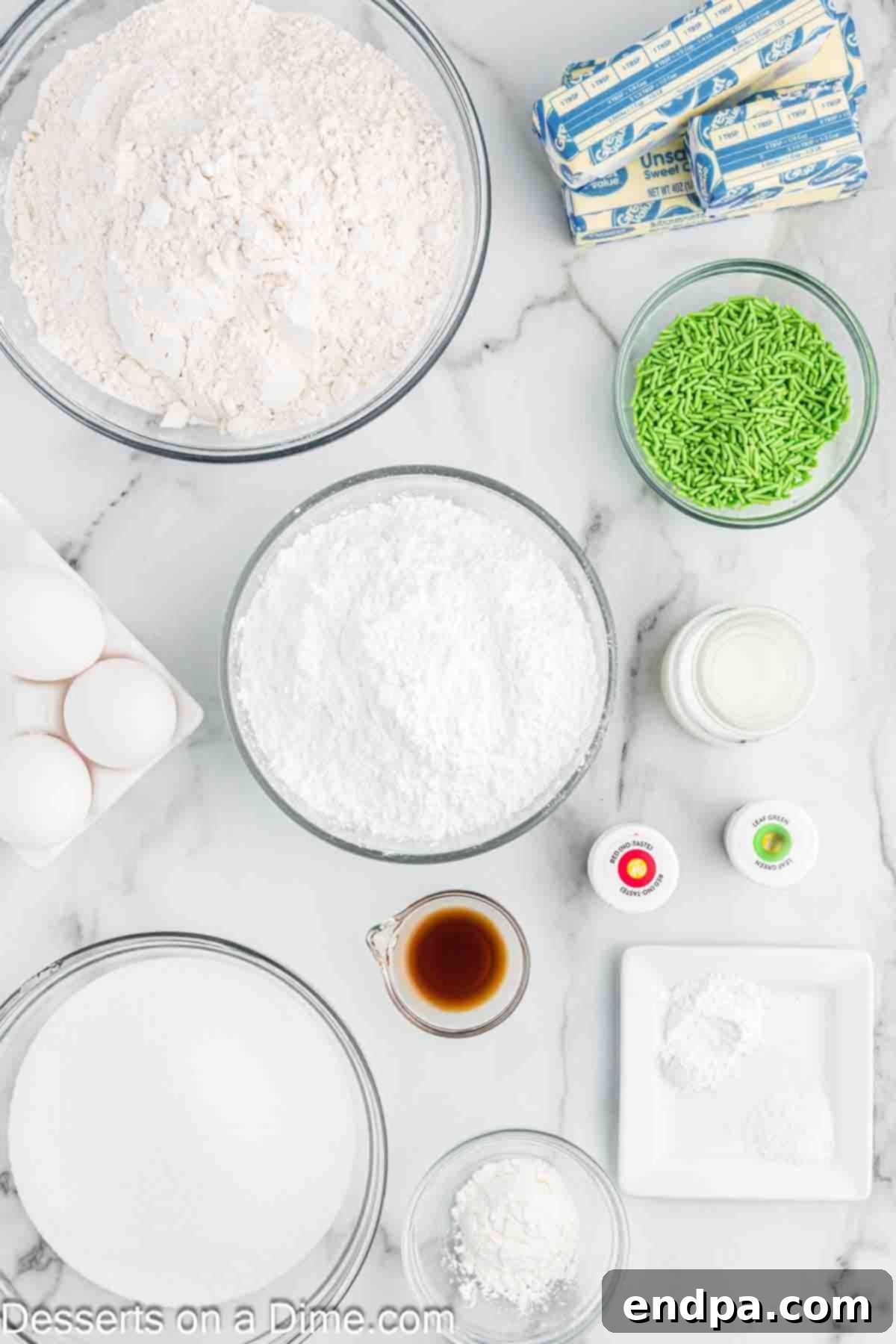 Ingredients for soft and delicious Grinch cookie bars, including butter, eggs, vanilla, flour, green sprinkles, powdered sugar, and vibrant food coloring.