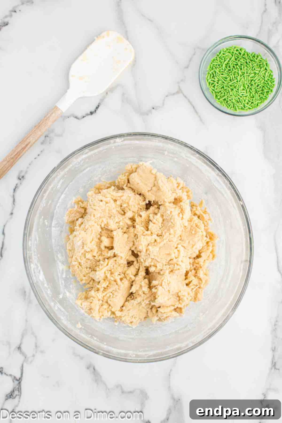 Dry ingredients including flour, baking powder, and salt, being gently folded into the wet dough mixture.