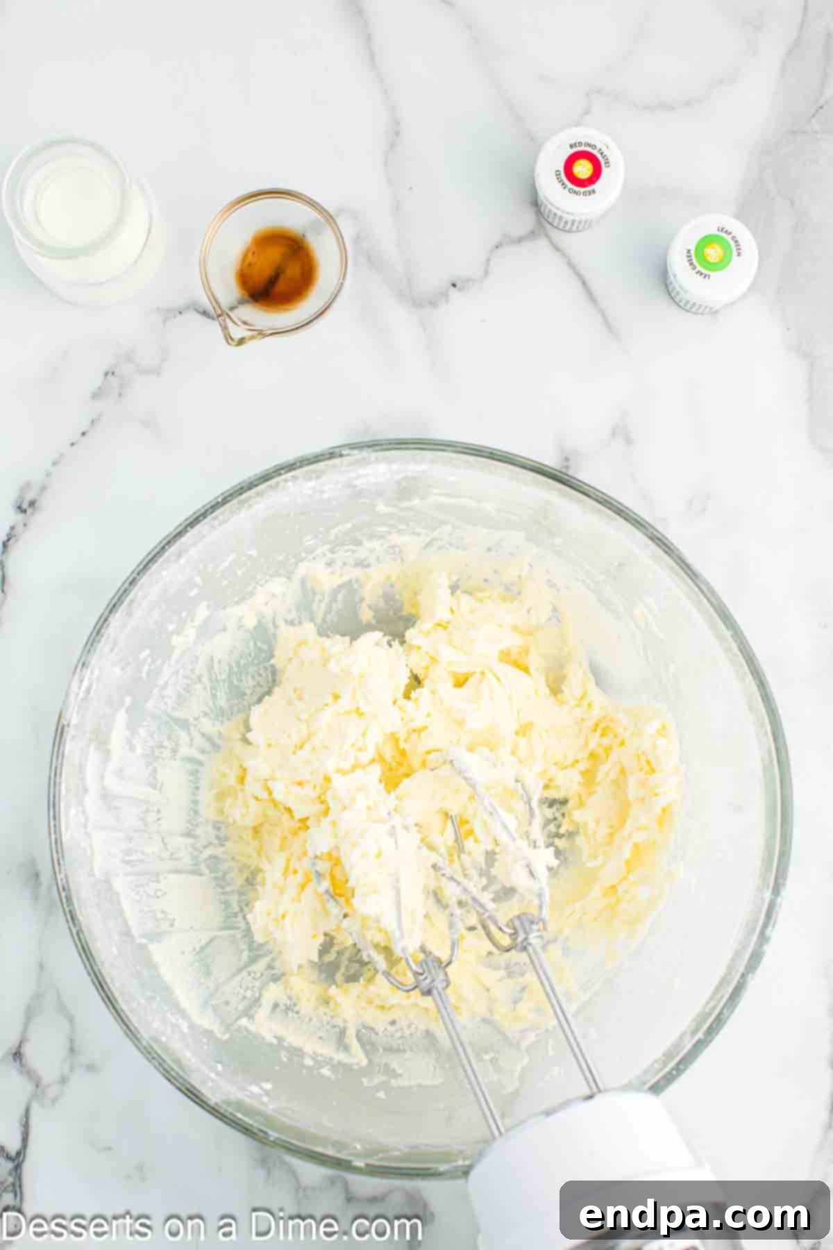Softened butter and powdered sugar being creamed together for the frosting base.