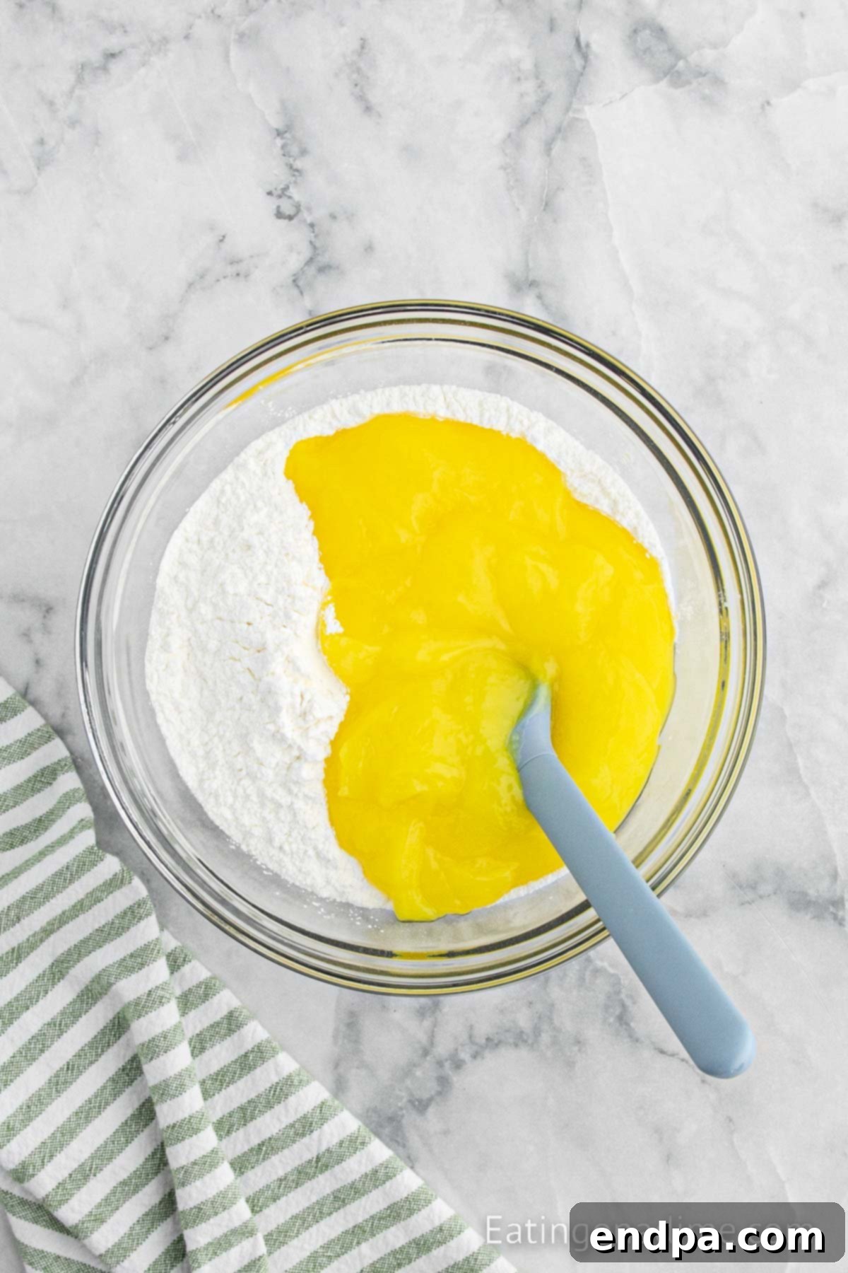 Sunshine Lemon Angel Delight 4 Cake mix combined with lemon pie filling in a bowl.
