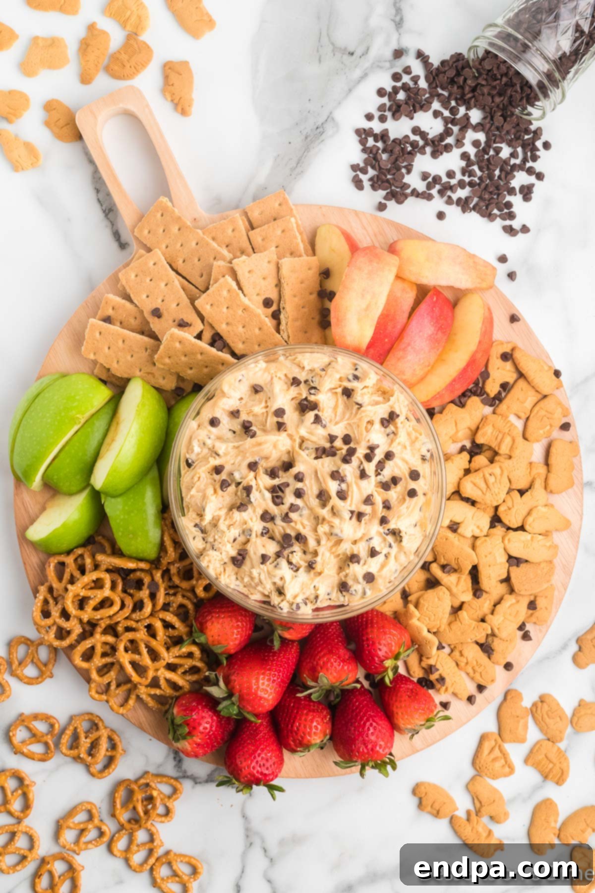 Dreamy Peanut Butter Chocolate Dip 7 A beautifully arranged serving platter featuring a central bowl of Buckeye Dip, surrounded by a delightful assortment of dippers such as pretzels, apple slices, and various graham crackers, ready to be enjoyed.