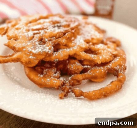 Easy Bisquick Funnel Cake, making fair favorites at home without the wait.