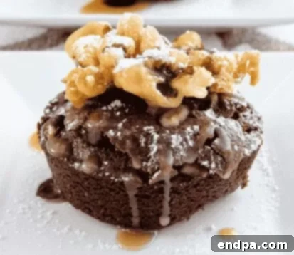 Decadent Cupcake Brownie Funnel Cake with Caramel Sauce, a rich stacked dessert.