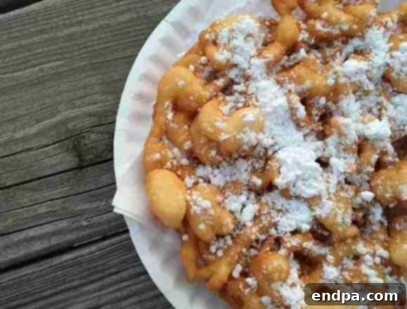 Deep-fried Classic Funnel Cake, crunchy and golden brown, ready for any topping.