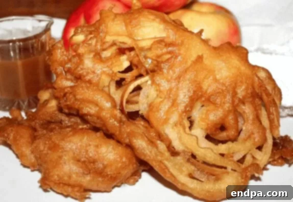 Apple Stuffed Funnel Cake, blending crispy fried dough with sweet apple filling for a delicious treat.