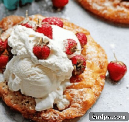 Strawberry Shortcake Funnel Cake, a fun seasonal twist on a classic dessert.