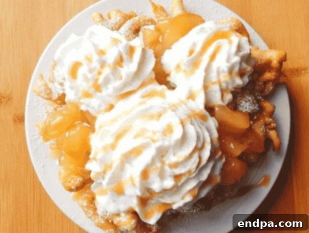 Disneyland’s Apple Funnel Cake, topped with apple pie filling, caramel, and whipped cream.